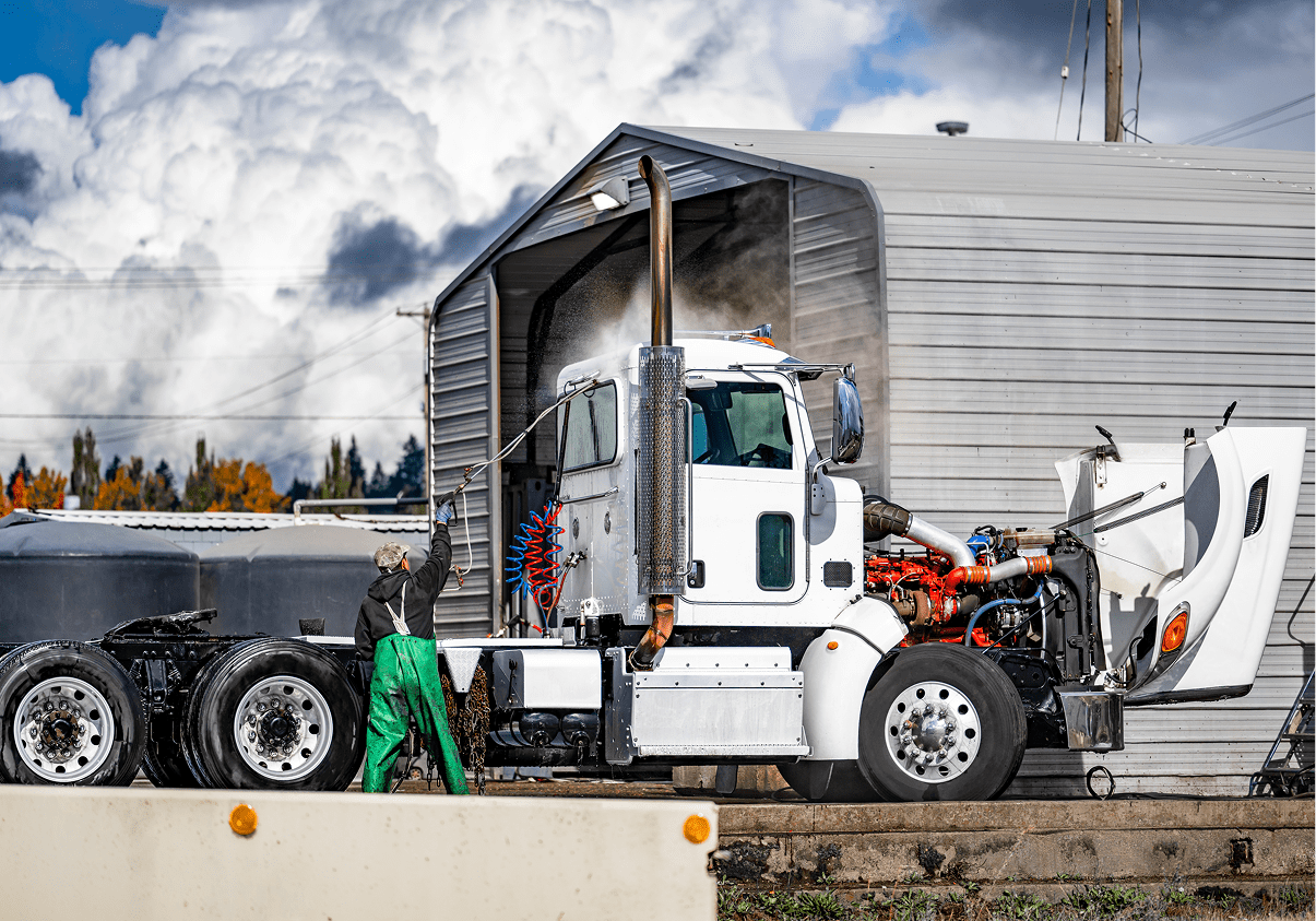 Truck being washed at industrial site.